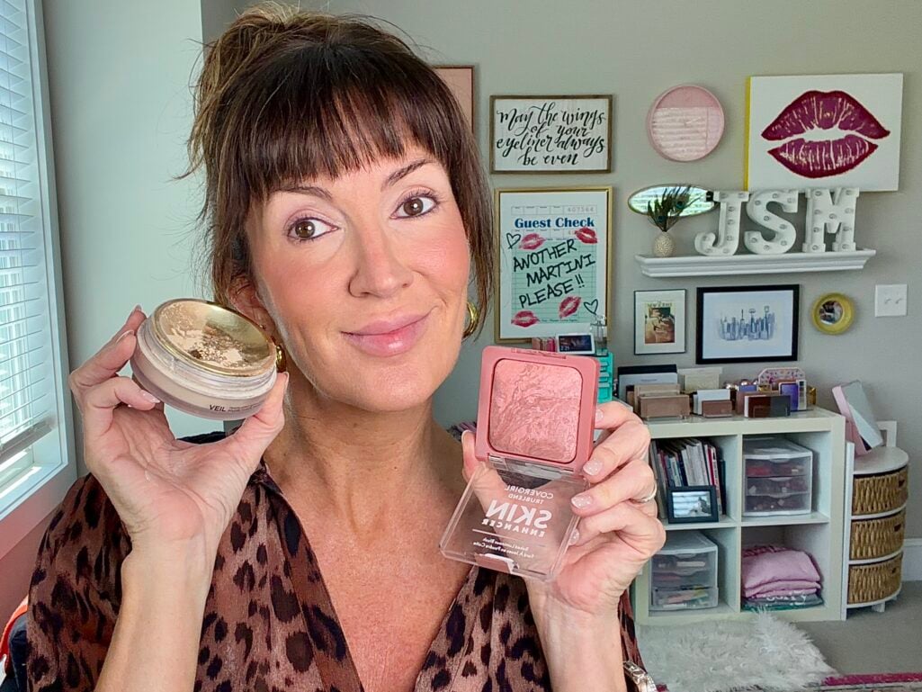 Holding Hourglass Veil setting powder and CoverGirl Luminous Baked blush