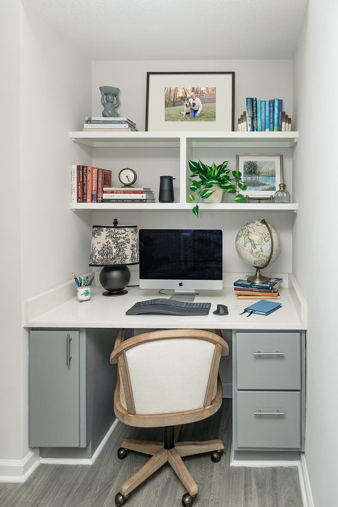 Atlanta apartment study nook reveal from Labor Day Weekend Notes: white floating shelves, gray built-in desk, black toile lamp, and rattan chair.