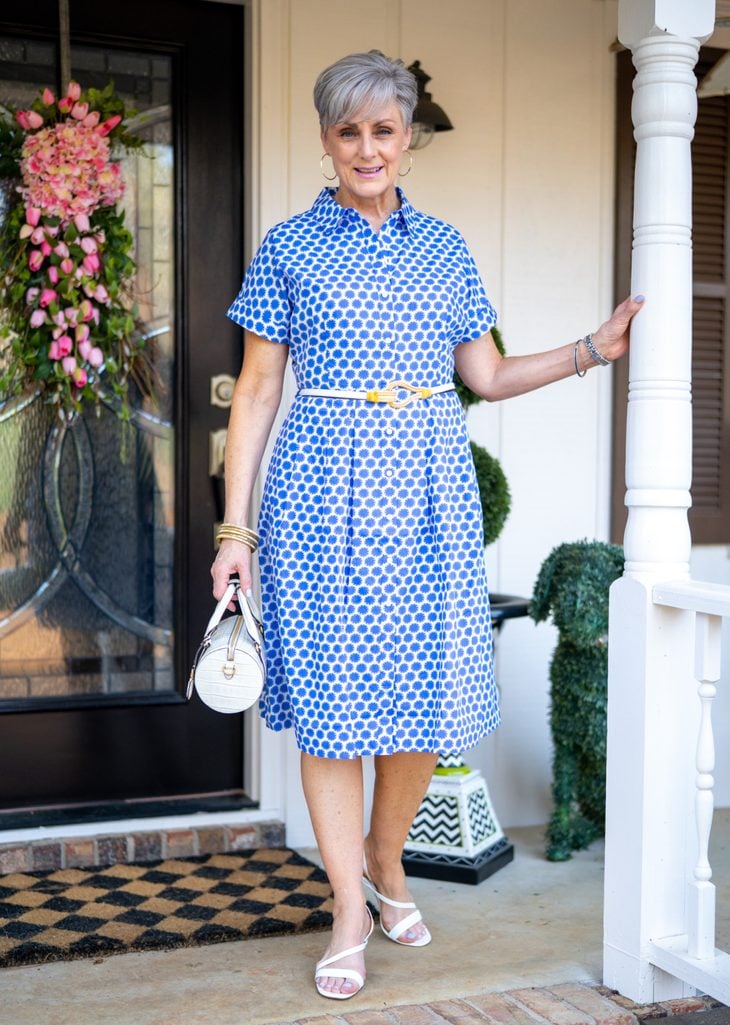 Beth Djalali in a blue and white daisy print Talbots shirtdress on her Athens front porch, April 2021