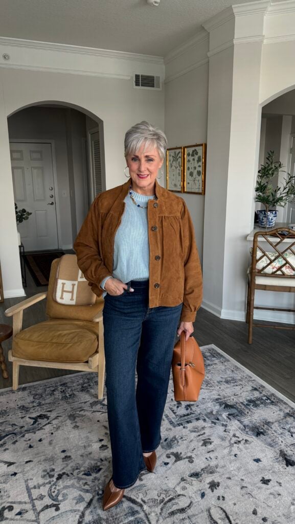Fall jean trends for women over 50 — wide-leg jeans with the hem grazing a flat shoe.