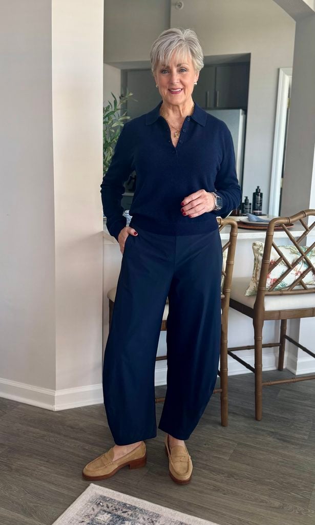 Navy cashmere polo sweater with navy barrel pants and tan suede loafers