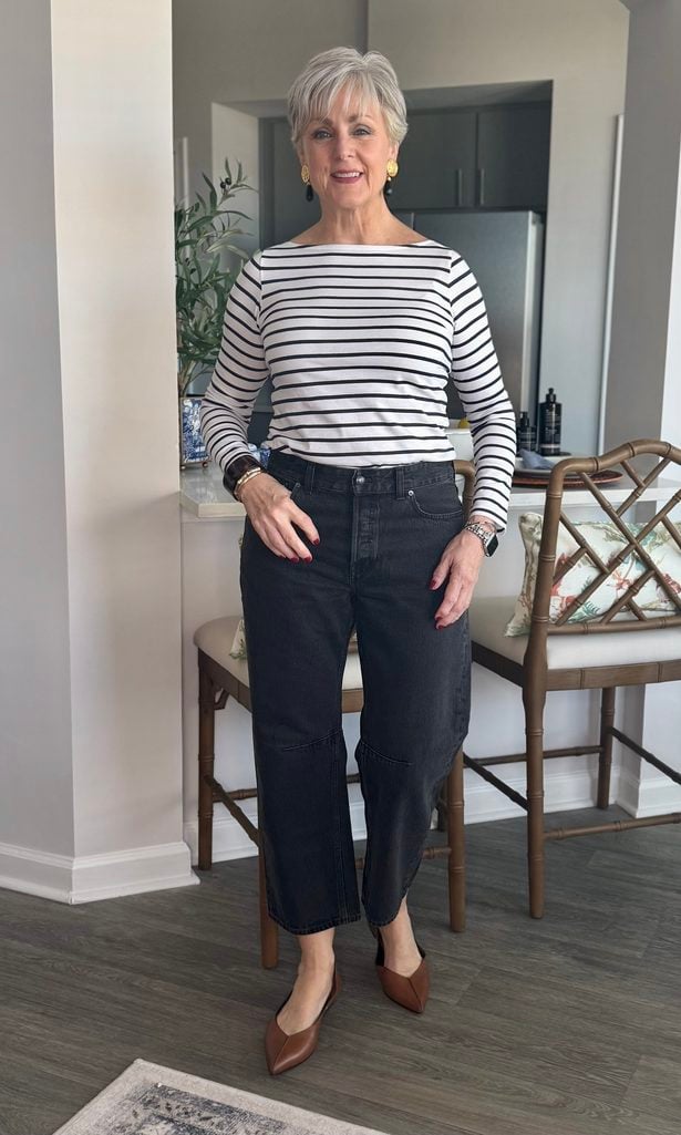 Striped boatneck tee with washed black barrel jeans and brown slingback flats