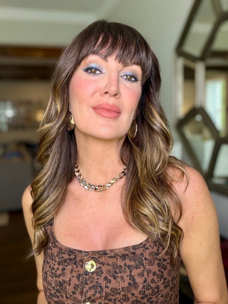 Finished makeup look with denim blue liner and teal shimmer