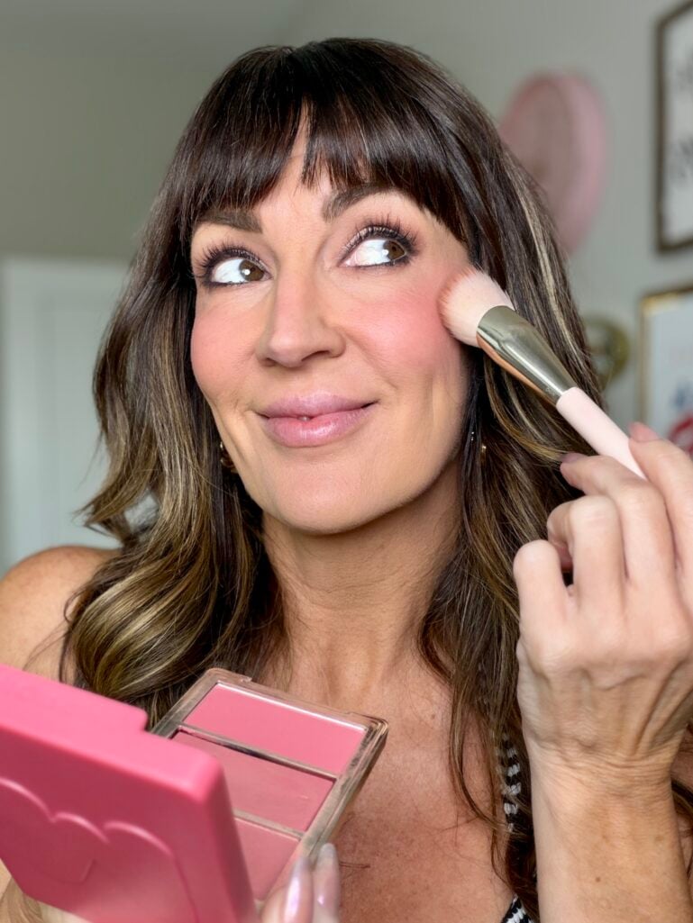 Jennifer Duvall applying pink blush high on the cheekbone from the Morphe Cheek Thrills trio in shade Blind Date