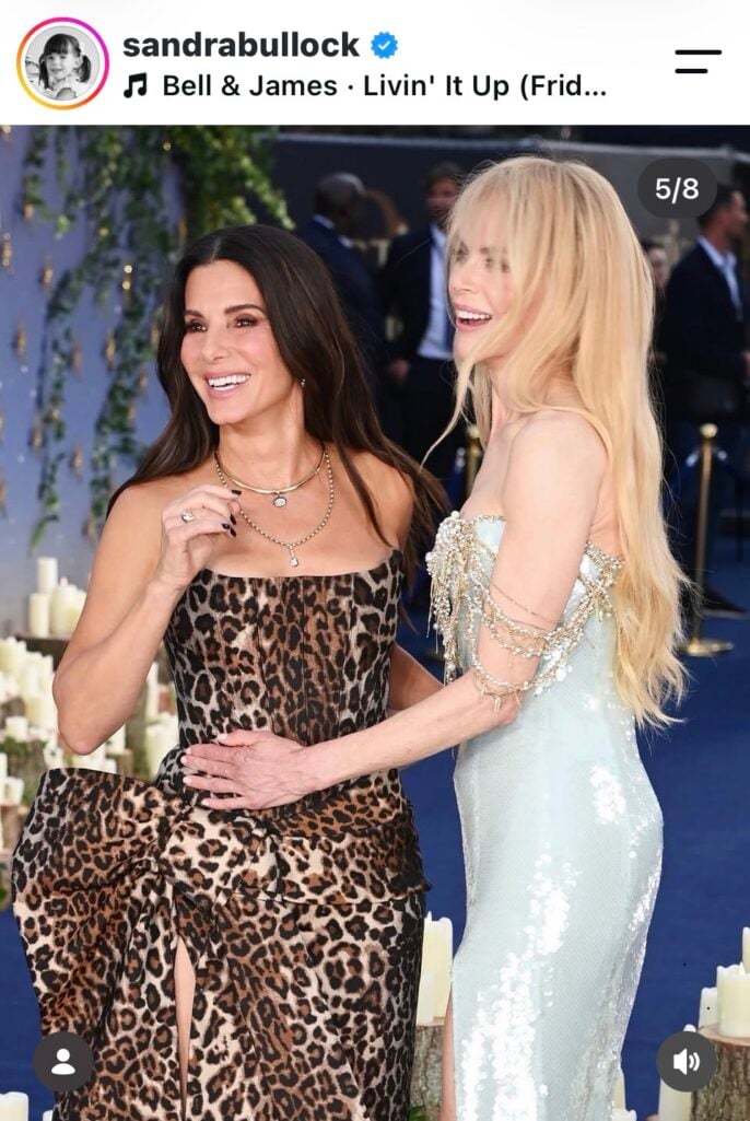 Sandra Bullock in leopard print and Nicole Kidman in pale blue sequins laughing together on the blue carpet, from Sandra Bullock's Instagram