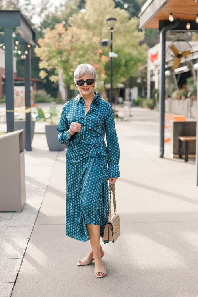 Teal foulard print wrap midi dress with nude slides and a taupe bag
