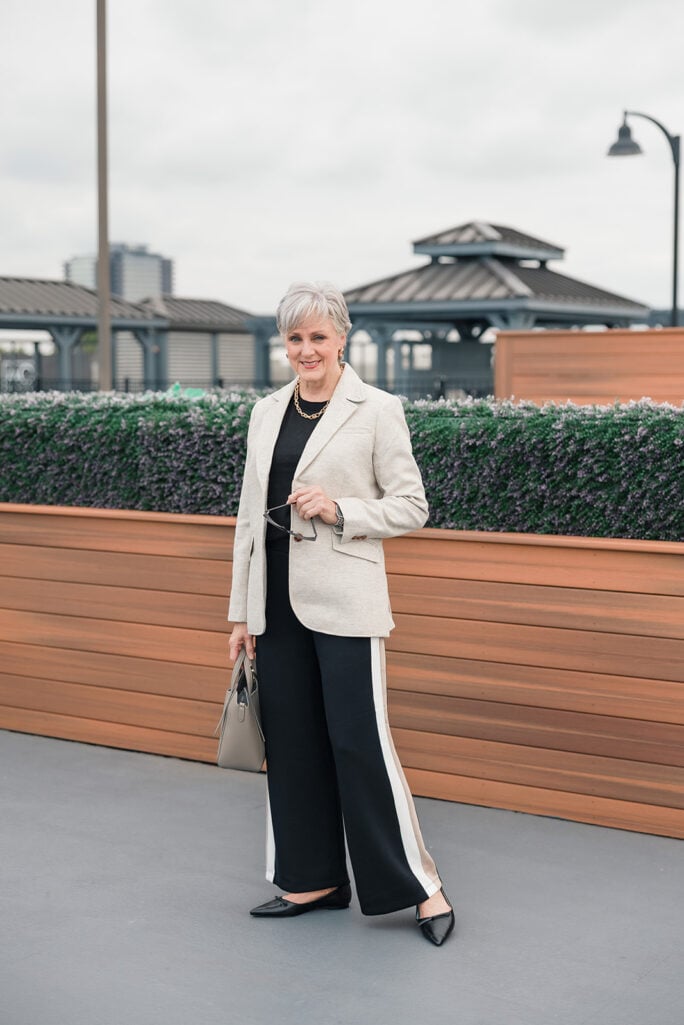 beth in track pants, black cashmere tee, Shetland blazer, pointy flats, leather tote