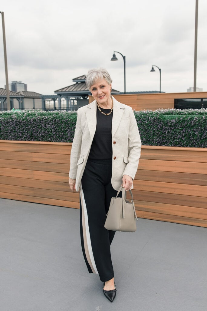 Oatmeal Shetland blazer with a black tee, wide-leg track pants, and pointed flats