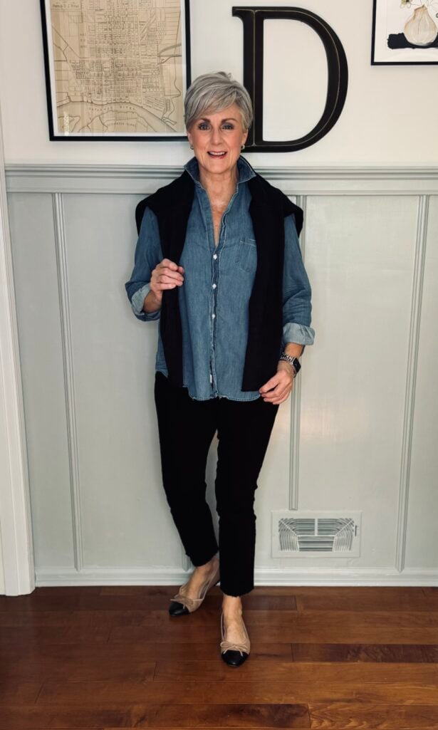 Beth in denim shirt, black jeans, cardigan and flats