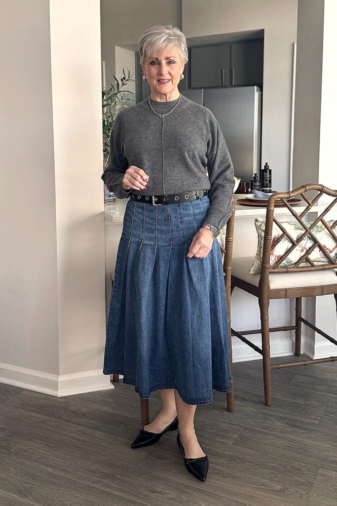 Beth in gray cashmere sweater and denim midi skirt