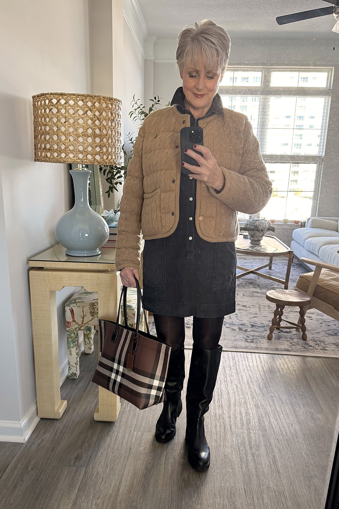 Black denim shirtdress styled with tall boots and a blazer