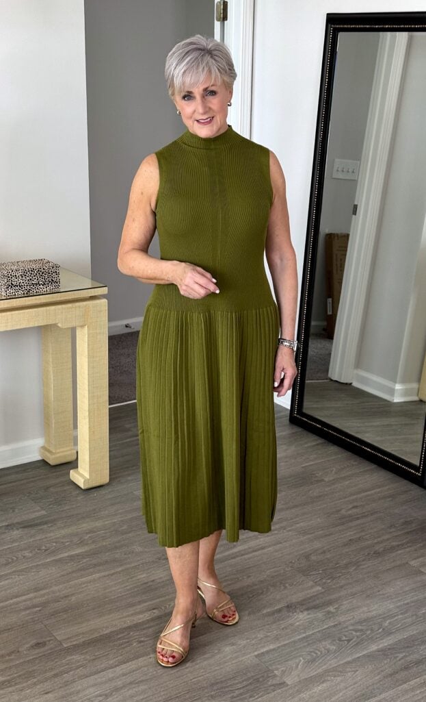 Affordable fall dress for women over 50: moss green pleated knit midi with gold sandals 