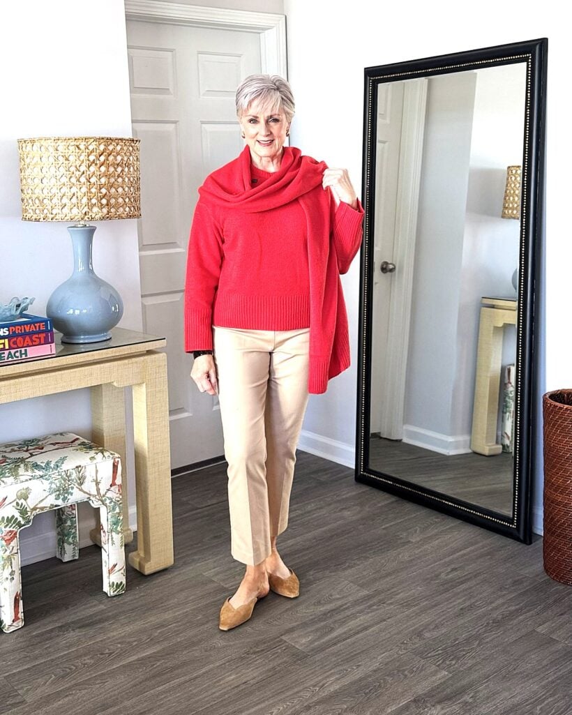 Beth in red scarf sweater, camel pants, suede mules