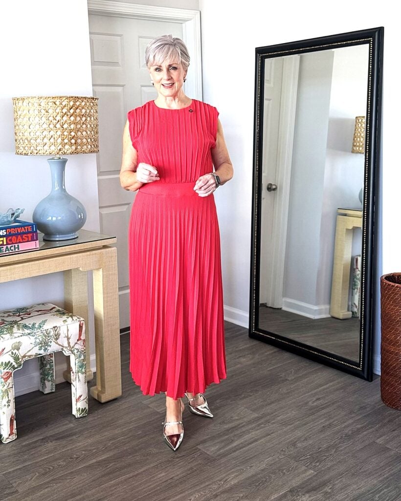 Beth Djalali in a pleated red maxi dress and silver pointed slingbacks, one of five affordable fall outfits for women over 50
