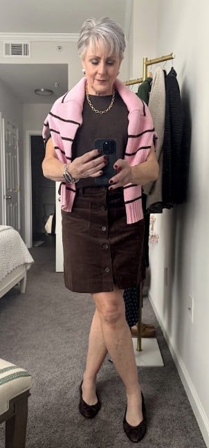 Beth in cashmere sweater and corduroy skirt