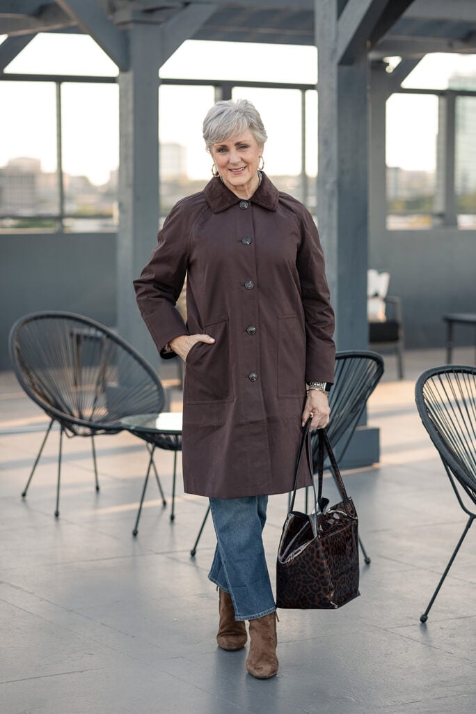 Long Mac with a corduroy collar, straight-leg jeans, and a leopard patent tote