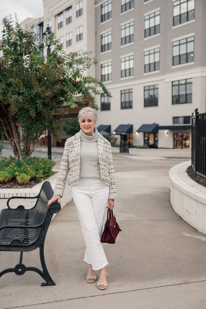 Cropped tweed blazer with a turtleneck and white straight-leg jeans