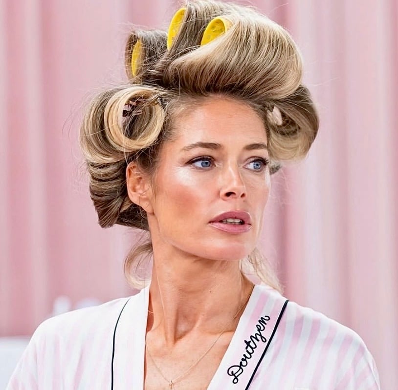 Model in rollers during VS bombshell hair prep
