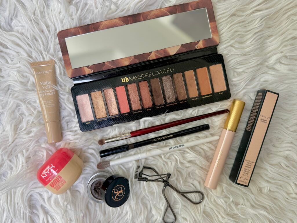 Flatlay of products used for hooded‑eye makeup