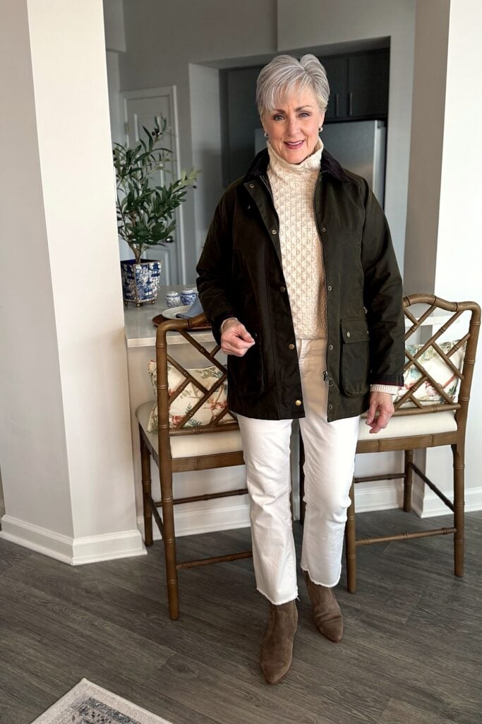Waxed cotton jacket with a cream fisherman sweater and cropped white flares